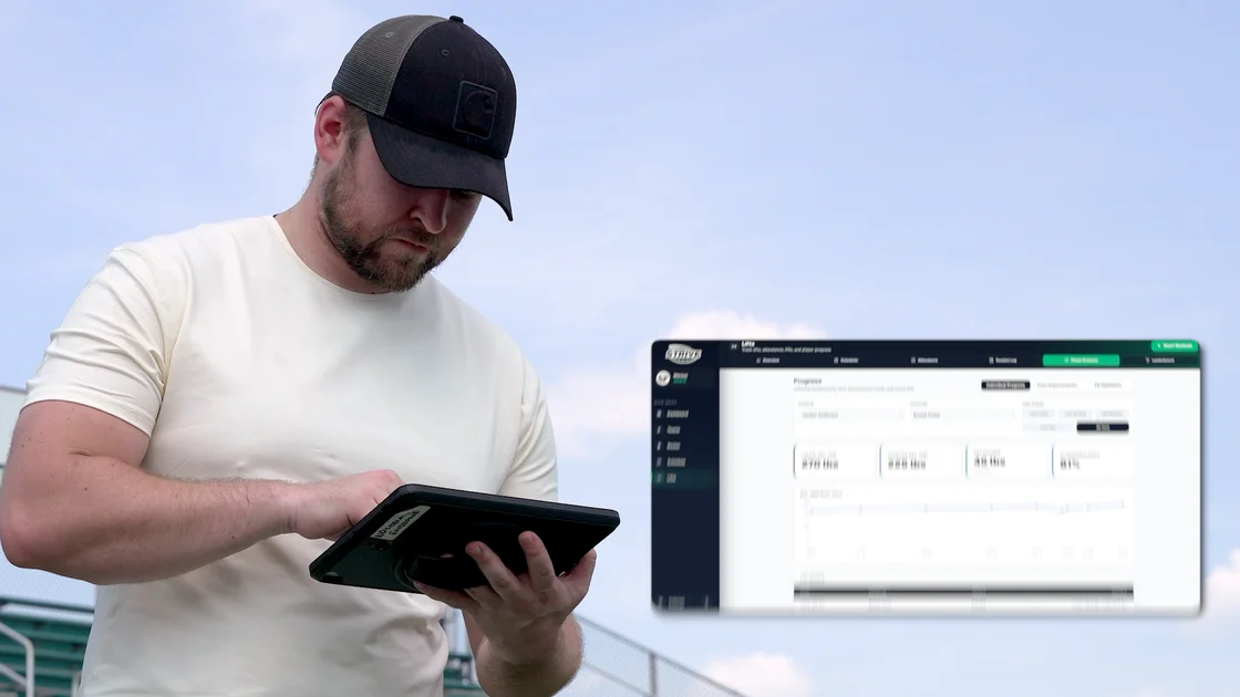 Coach using Strive on a tablet at the football field, from the commercial.